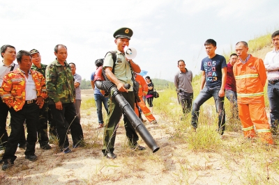 武警泉州森林大队官兵讲解风力灭火机的使用要领。实习生李想摄