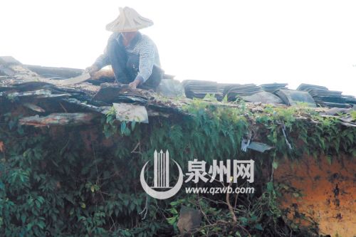 工人修补破损的屋瓦