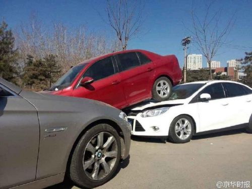 事故现场，一辆香槟色宝马车，车头将一辆红色轿车顶起。被顶起的红色轿车，后半截车身骑到了后方一辆白色轿车上。