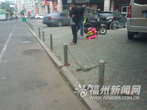 停车场栏杆之间的铁链绊倒行人