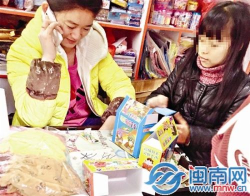 小女孩（右一）正在购买“彩票”，一旁是店老板
