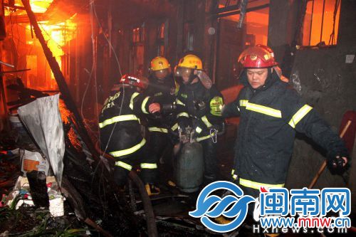 消防队员从民房中抢出液化气罐