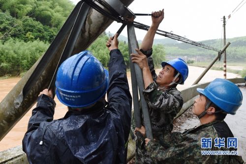 5月9日，电力工人在灾害现场抢修受损电力设施。