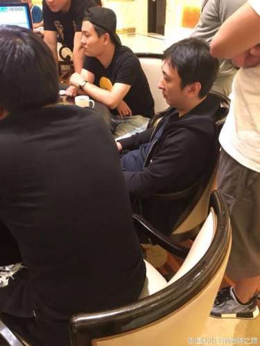 "照片中王思聪与众人同坐,一身黑色休闲装十分低调,只露出侧脸,表情