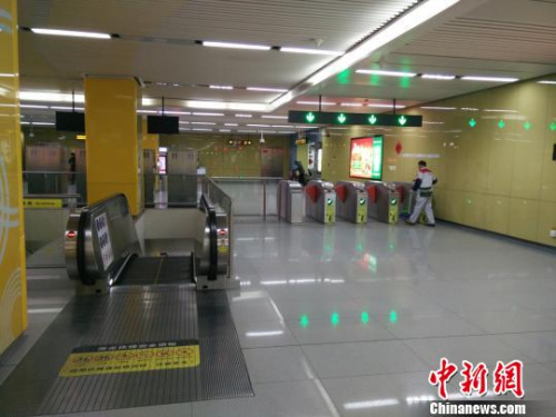 17日，一位保洁大爷正在发生事件的自动扶梯不远处打扫卫生。　钟升 摄