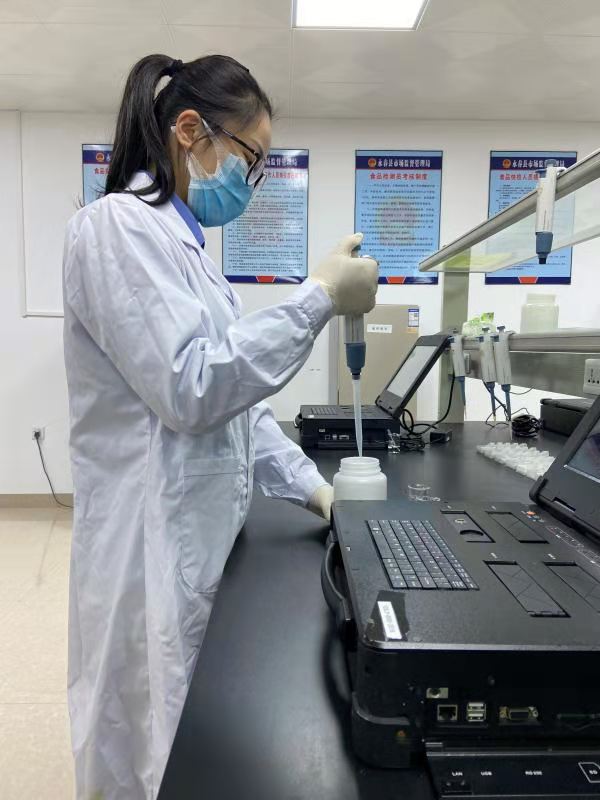 永春县基层所快检室内一工作人员正在进行农残快速检测