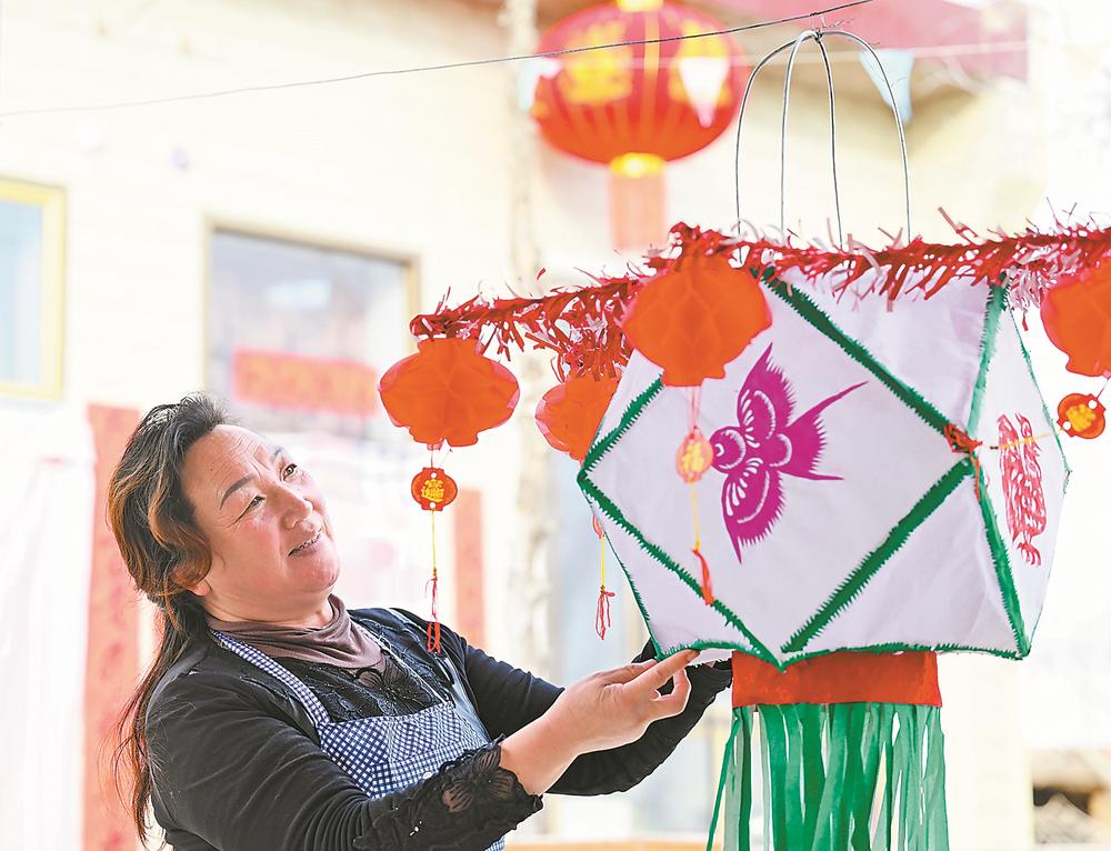 2月16日，在宁夏银川市永宁县闽宁镇福宁村，村民韩树琴在整理自己做的纸灯笼。今年是闽宁协作30周年，因闽宁协作而生的闽宁镇也将迎来29岁生日。新华社