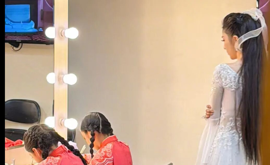 佟丽娅穿着仙女裙 在演出后台给孩子报听写